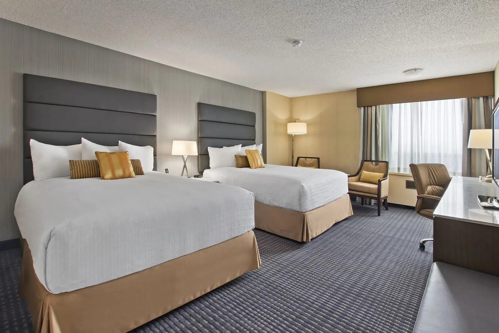 Two queen beds in a Select guestroom at the Calgary Plaza Hotel & Conference Centre