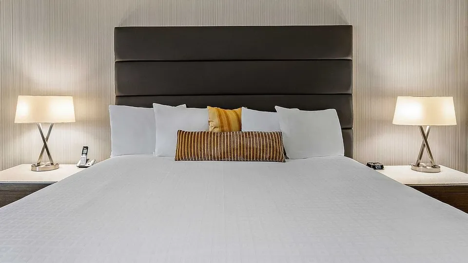 Nightstands by the bed in the Elite Room at Best Western Premier Calgary Plaza Hotel