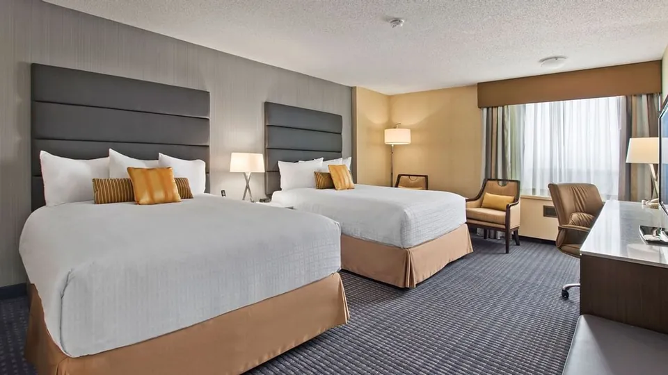 Bed and furniture in the Select Room at Best Western Premier Calgary Plaza Hotel